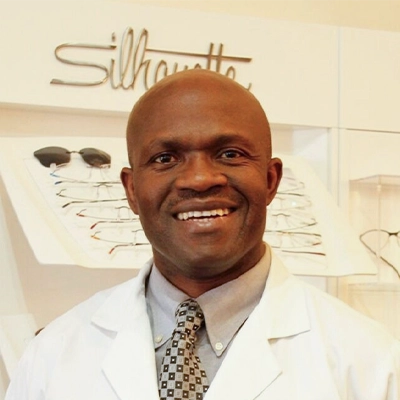 Eye Doctor Kunle Oluwadare Smiling In Lab Coat