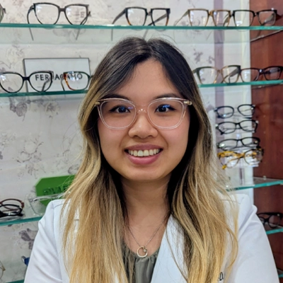 Eye Doctor Dr. Nguyen Smiling In Front Of Glasses